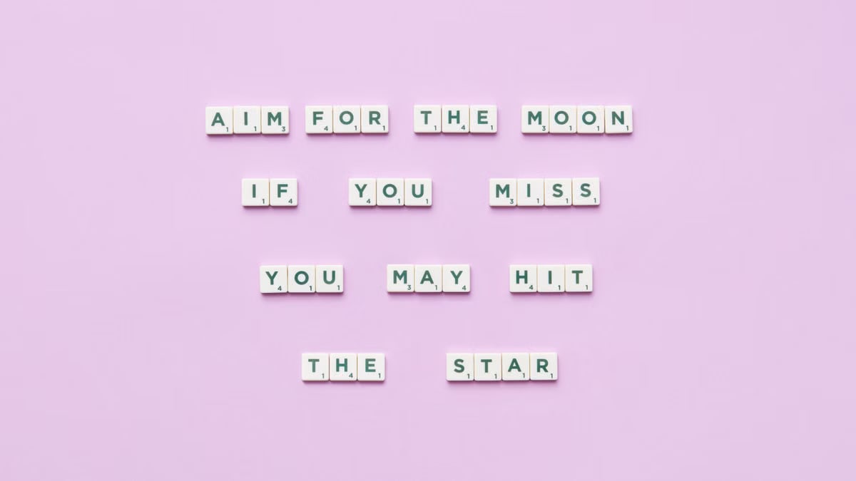 Inspirational message using Scrabble tiles on a pastel background.